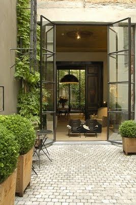 Glass doors with potted boxwoods