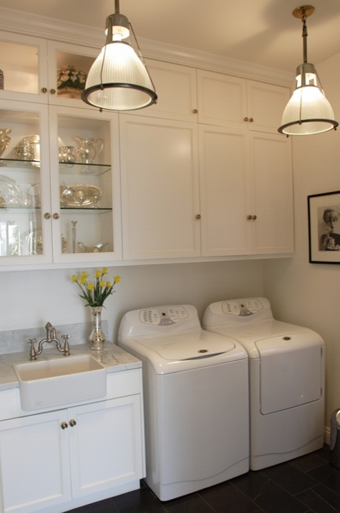Laundry room with light fixtures and white cabinets