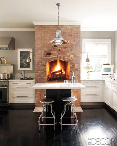 A dreamy kitchen with a brick oven fire via Elle Decor