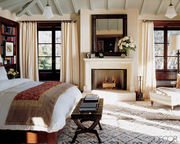A fireplace in the bedroom of Cindy Crawfor designed by Michael S Smith via Elle Decor