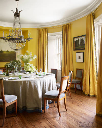 A yellow and circular dining room in Nashville by Brookschmidy and Coleman in Elle Decor