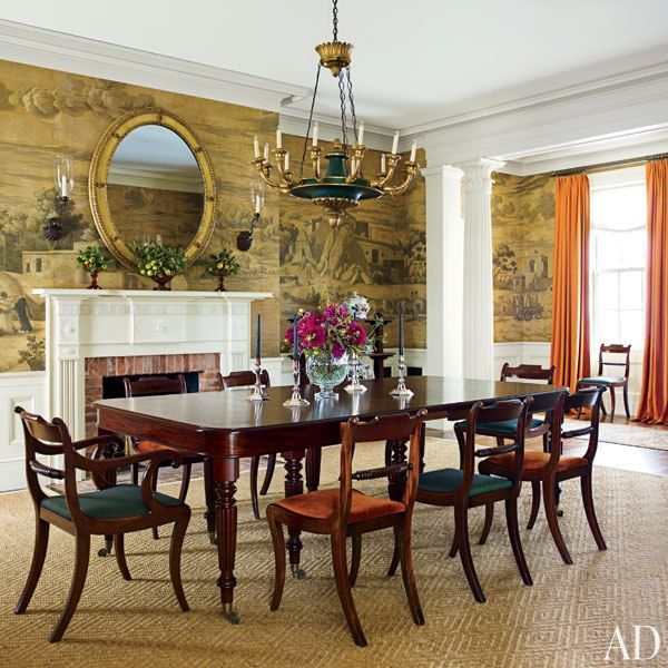 Dining room with a fireplace in a NY home by Gil Schafer