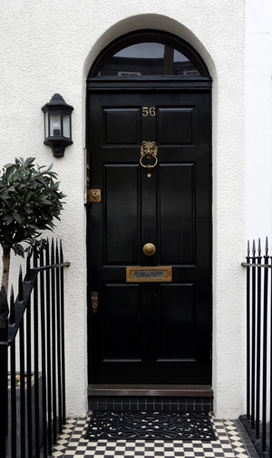 Classic black front door with knob in the middle