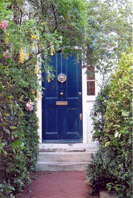 Rustic blue front door withknob in teh middle