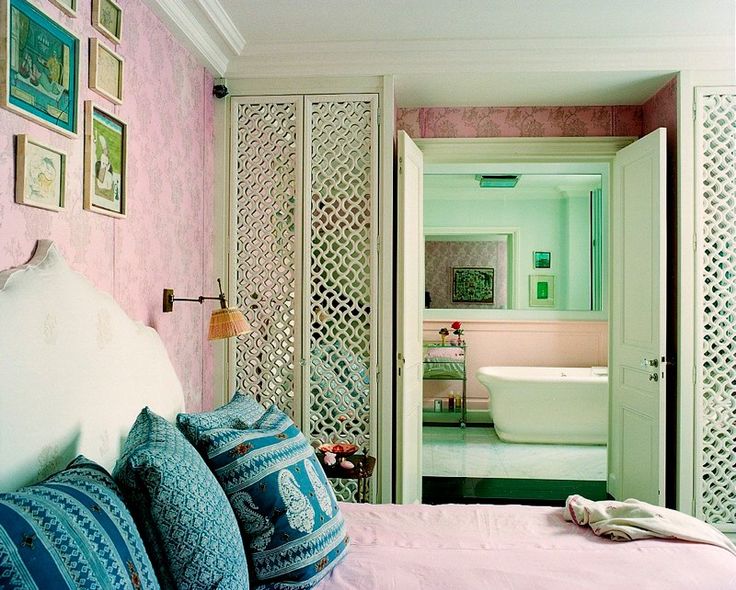 lattice pattern on shelving creates an open space in this bedroom via Lonny