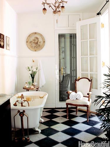 Checkerboard floors in a charming bathroom via House Beautiful