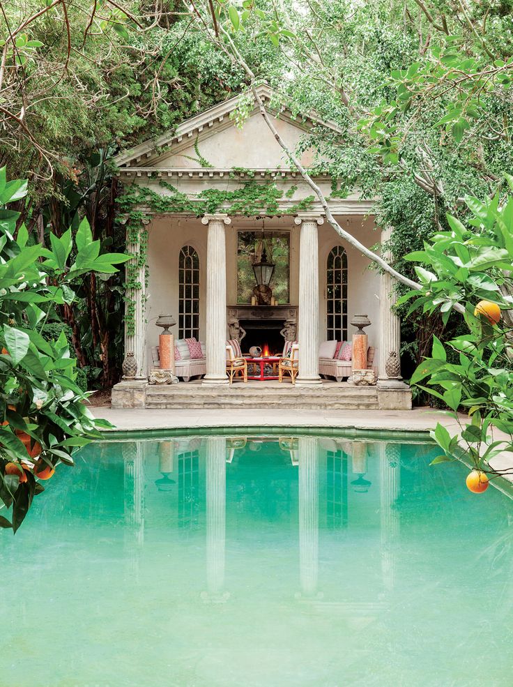 The pool house amid the rampant growth of ivy, citrus trees and ficus by Richard Shapiro design