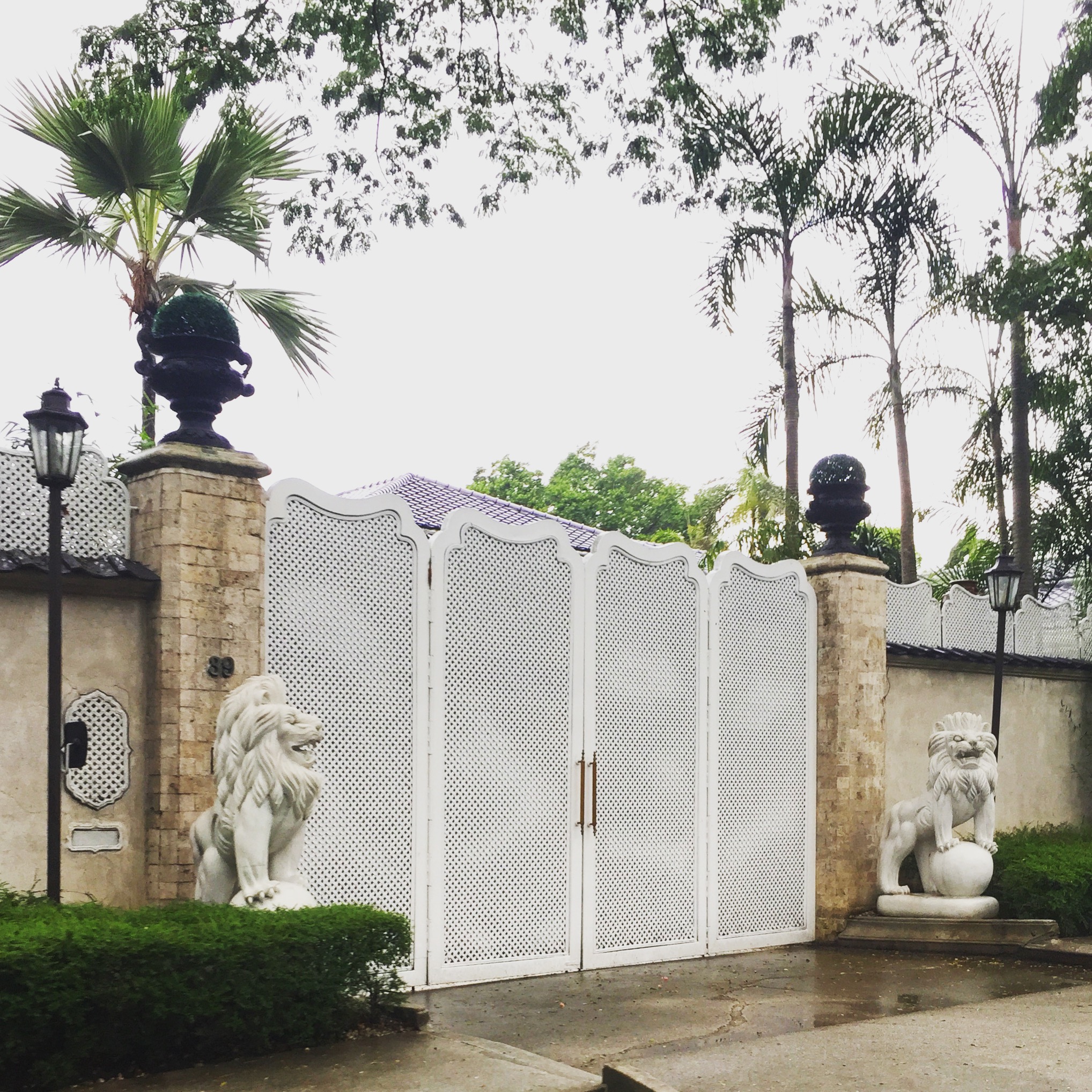 Gated enterance in Manila via The Potted Boxwood