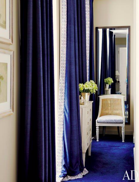 Navy curtains and blue carpeting via AD