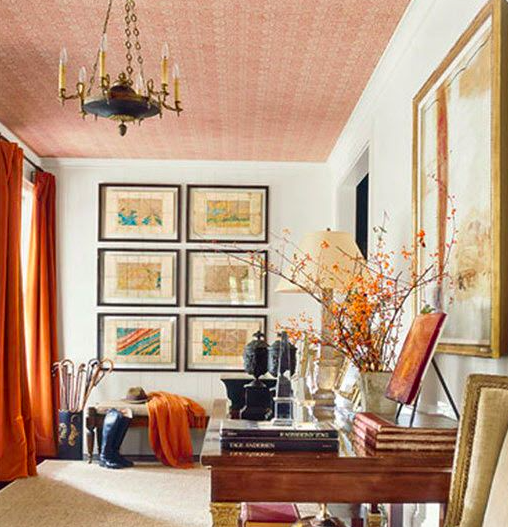 Orange velvet curtains and a patterened ceiling make the perfect pop